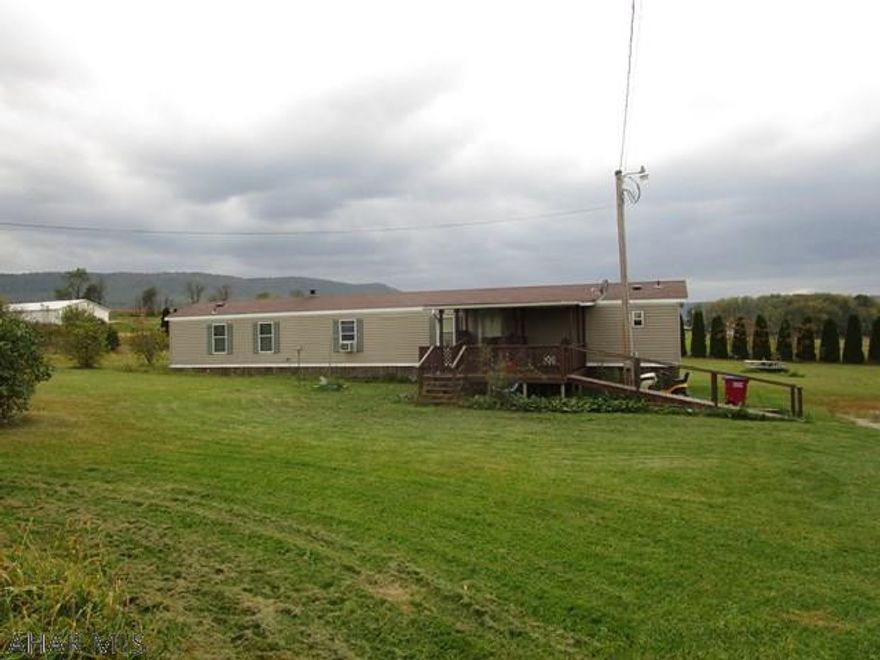 1999 16' x 76' Holly Park mobile Home.  It features 3-bedrooms, a living room, kitchen and two full baths.  Home has oil forced air heat, city water and private septic. Large, flat 2.586 acre lot with nice views of the surrounding countryside!  Nice location and affordable housing!!