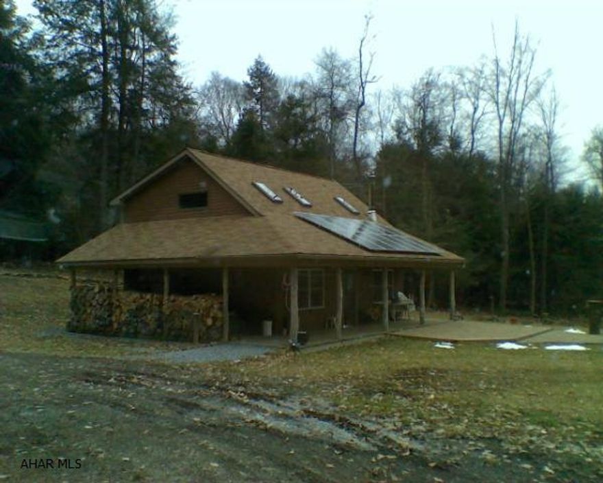 Fabulous hunting camp/summer home in secluded area but within a few miles of Prince Gallitin State Park. 54.6 Acres mostly wooded with good hunting. Game lands nearby. Camp has solar heating and electric storage. Hickory kitchen.