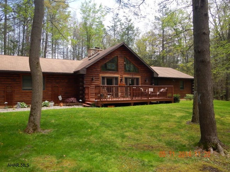 A log cabin in the woods with a stream and two acres of land. Large great room with vaulted ceiling and fireplace in the center.  Large master bedroom with walk in closet.  Master bathroom has been updated with a walk in shower and rain shower. Bathroom floors are heated.  Entertain in the heated sunroom or go to the deck with a 24' above ground pool. Three other bedrooms are all good size. Has a large family room and an office with all the needed connections. Comes with two pellet stoves to keep your heating bill low.  Also has a two car garage with a large second floor for storage.  Includes a shed for all your outdoor equipment. Comes with lots of lights and electrical outlets outside.  Very Very private yet close to all the amenities.  Home is agent owned.