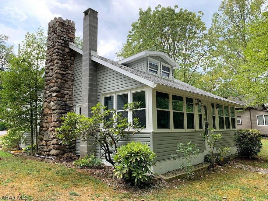 Exceptional cottage perched along the Raystown Branch of the Juniata River! Newly remodeled w/ endless updates. Can be used for year-round living or part time enjoyment. Main level offers a living room w/ stone hearth wood fireplace (gas insert can be removed), updated kitchen w/ cherry cabinets, dining area open to the LR, full remodeled bath, laundry room w/ sink, mechanical room, & a glorious sun porch for enjoying the flowing river. Second level offers two bedrooms. Newer roof, siding, gutters, soffit, fascia, windows, and 200-amp electric. Private well w/ a water softener & filter tap water & private septic system. One-car detached garage w/ loft. Flagstone patio w/ firepit, covered porch & a bench by the river. This is a beautiful property that has been impeccably maintained!!
