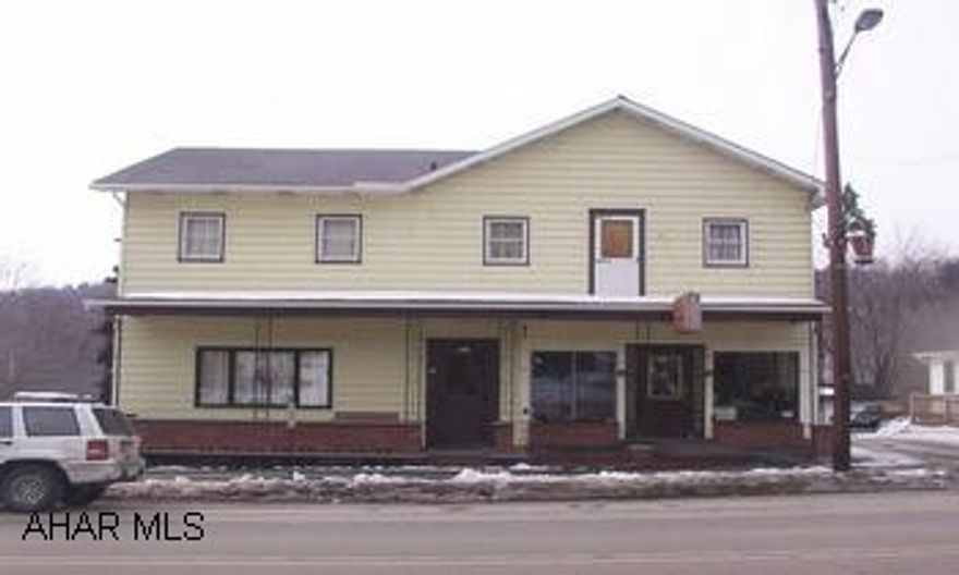 Shown by appt. only.   4 unit apartment building consists of 2 two bedroom apartments and 2 one bedroom apartments plus a commercial storefront and kitchen presently rented to a pizza shop.  Long-term renters.  Separate electric and new roof.   Oil hot water and electric heat.   Motivated seller.  Minimum $2500 commission.