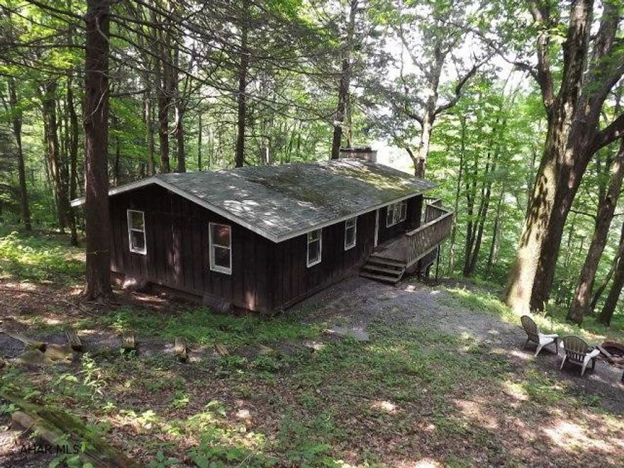 Secluded and very private hillside ranch on 3.3+ acres and surrounded by mature hardwoods. Two full floors of living which includes 4 bedrooms, 2 full baths, 2 wood burning fireplaces, and 2 decks. Master bedroom has a half bath. Lower level is 85% completed! Quick access to Bob's Creek and Blue Knob. Just minutes to I-99. $40/month fee which covers road maintenance, snow removal, septic, and water.