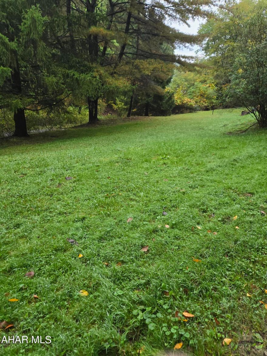 Build your dream home in the woods on this 2.76 AC parcel! There is a mobile home, which is not livable, on the lot at this time with well, septic and electric to it. Map attached.  Property being sold AS IS.