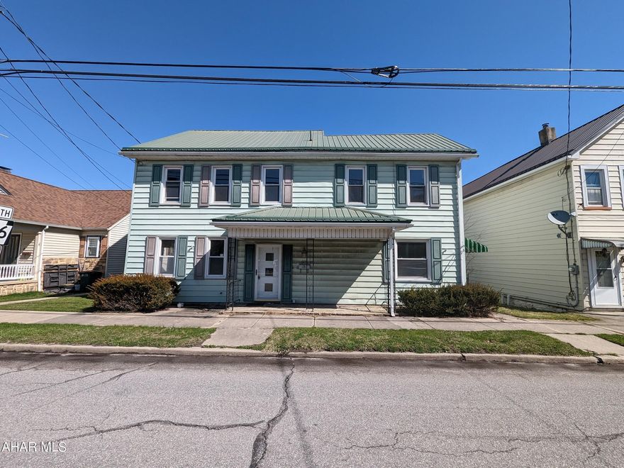 Absolutely huge 2 story vinyl Williamsburg home! Very large living room w/ FP and formal dining with laminate floors plus spacious eat-in oak kitchen with large dining area. First floor has office area w/ separate side entrance (former beauty salon) that could be used as an in-home business (check local zoning). Second floor with 2 huge bedrooms, 2 full baths plus additional living area with separate back stairway and entrance for many possibilities. Concrete block 2 car detached garage and storage shed. AS-IS sale, seller will make no repairs.