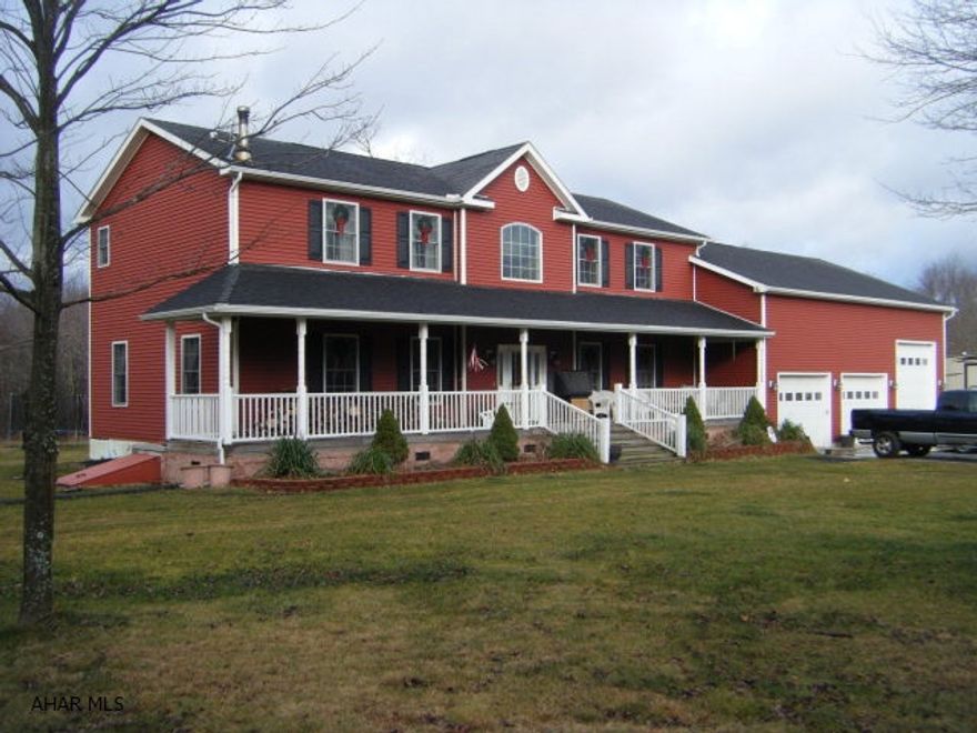 8 year old, modular 2 story on 7 acres with level lawn. 36x40 attached garage with 17' clearance. How water heat system with wood/coal furnace in garage. There is also, an electric wall hot water boiler in the basement as a backup. Radiant heat in the basement and garage floors. (2) 200 amp electric services. Pella windows. Attached wood storage/patio structure at the rear. Full unfinished basement with 9' ceiling. First floor has 9' ceilings.