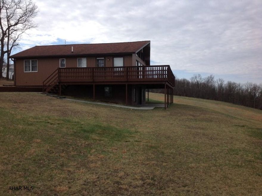 This home could be a full time residence or weekend retreat. The 360 degree panoramic view is one of the best in the county. Custom home with room to add on or finish the walk-out basement. Basement is light and open with many windows. This home has a beautiful fire place on both levels. Living room, kitchen, and dining is a wide open floor plan that includes shiplap ceiling and plenty of space for entertaining. Custom built cherry cabinets. Finished additional space above 3 car garage. 220' well.