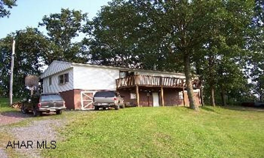 Trailer with addition on foundation and 1.5 acres. 2 miles from Lake Raystown. Newer roof, beautiful lot, very quiet. Owner will consider Article of Agreement.