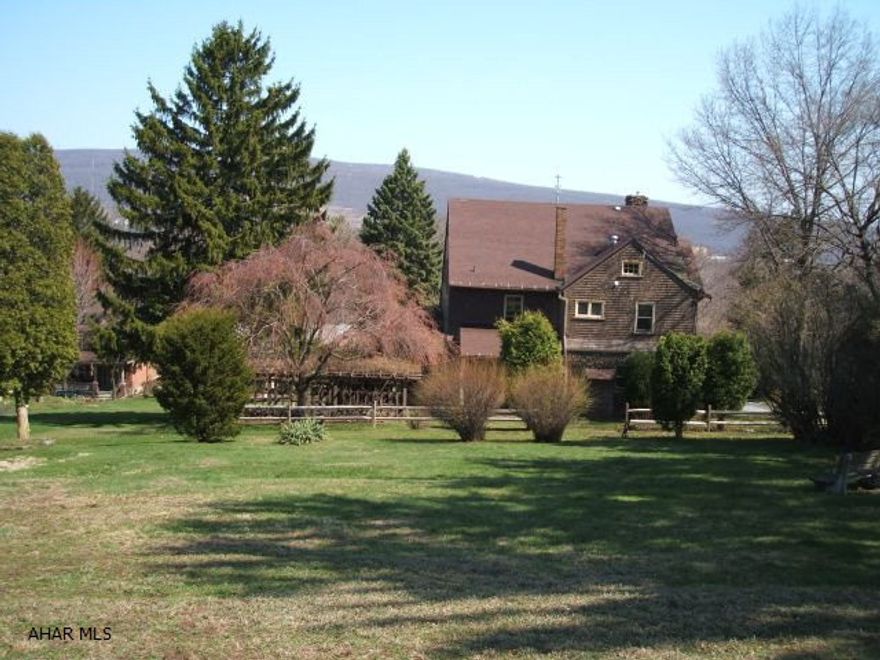 Spacious and Unique. 2 1/2 Story Creekstone and Cedar Home. 4 to 6 bedrooms. Hardwood Floors and Walnut Trim throughout. Rookwood Tile Fireplace in the living room. Stone Fireplace in 1st floor sunroom. Formal Dining Room with window seat. Master bedroom suite with full bath, sitting room and fireplace. Finished 23 X 15 area in the attic could be 6th bedroom. Also, plenty of 3rd floor storage. Two staircases. Awesome wrap-around porch. Beautiful .84 acre lot with assorted fruit trees and garden spaces. 36 X 12 Grape Arbor with electricity. Full house electric upgrade in 2010. New Furnace in 2009. This beautiful home gives you the picturesque privacy with all the city conveniences. Updates needed.