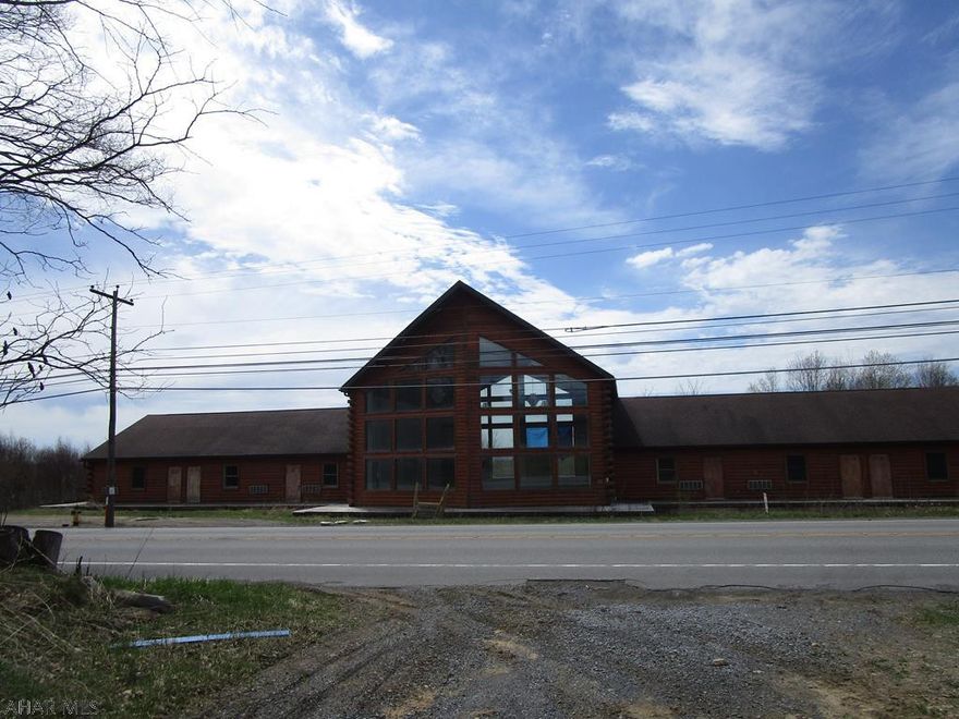 Large log building with lots of possible uses (church camp, apartments, etc). 8 separate bedroom/bath units and a large reception area. Full basement with superior walls. Building needs finished and wiring, heating. Approx 6,000 square feet of building plus basement.