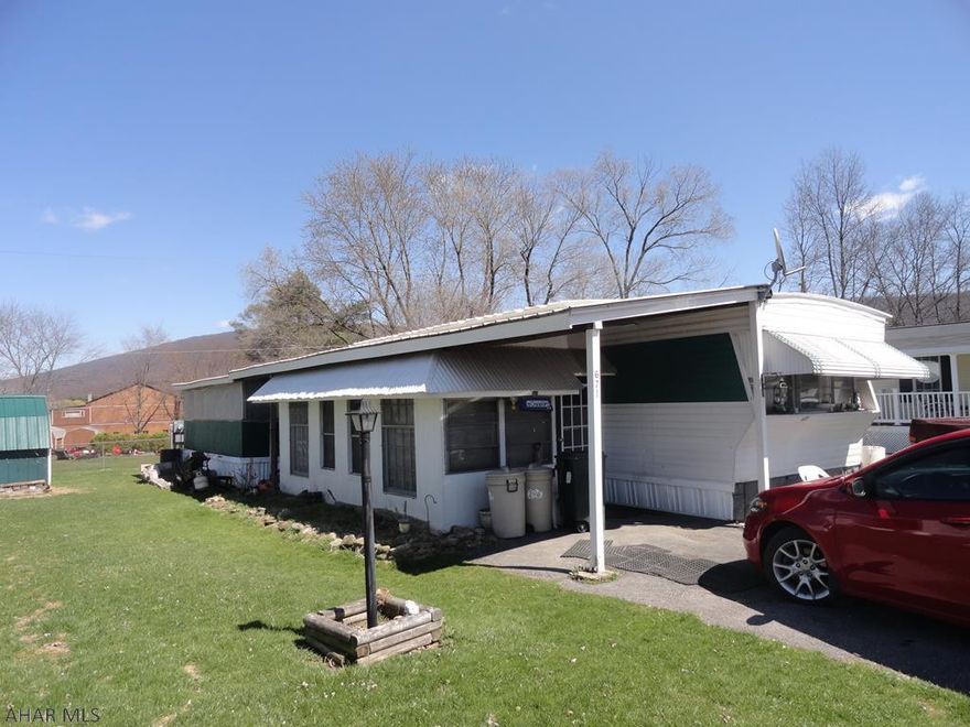 2 bed, 1 bath with newer furnace, roof, closed in mud room-handicap accessible, closed in sun room for summer fun, picnic table included & shed.  Needs some interior TLC.