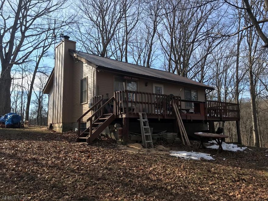 secluded property currently used as a hunting camp but can be used as a full time residence. oak plank hardwood flooring. metal roof. close state game lands. Additional 5 acres available for $25000.