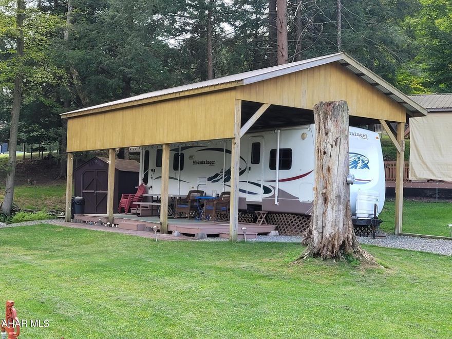 Elevate your camping experience by making this well maintained camper on two lots your own.  Enjoy the extra elbow room on the inside due to the two slide outs.  Then sit out on your open deck and enjoy watching the wildlife or just relaxing.  With the extra outside space you have room for play or privacy.  Two sheds will hold your toys and tools.