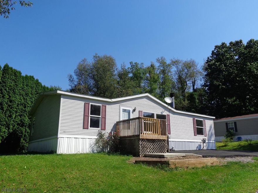 Camelot Woods doublewide that is open & spacious. Living room has a wood fireplace, large master bedroom with a walk-in closet. The master bathroom has a garden tub & a skylight. Large kitchen has plenty of countertops & cabinets. All kitchen appliances included.  Newer Gas furnace.  Lot rent $368.00 month includes sewer and trash.