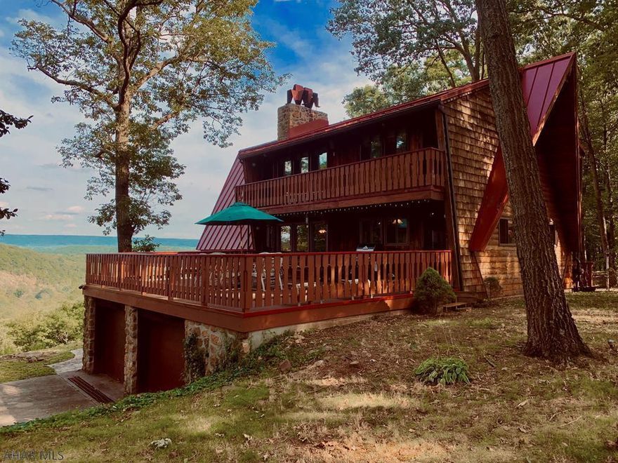 Wake up every morning to views that will mesmerize in a meticulously maintained Town & Country Western Red Cedar Chalet.  This is a home that will captivate and intrigue.  The European inspired chalet has 6 decks to take in magnificent views.  A new salt water pool where views feel endless, entertaining spaces that seamlessly blend interior and exterior spaces through walls of windows.  A soaring two story stone fireplace warms living spaces, while the home's green technology, ceramic block heaters and new energy efficiency pellet stoves ensure energy efficiency.  Copper finishes, granite counters, hardwood floors, solarium with sauna are just a few of the extras.  Add the 1000 sqft garage/barn & soaring mature trees and you have a home that will eliminate the need for vacations.