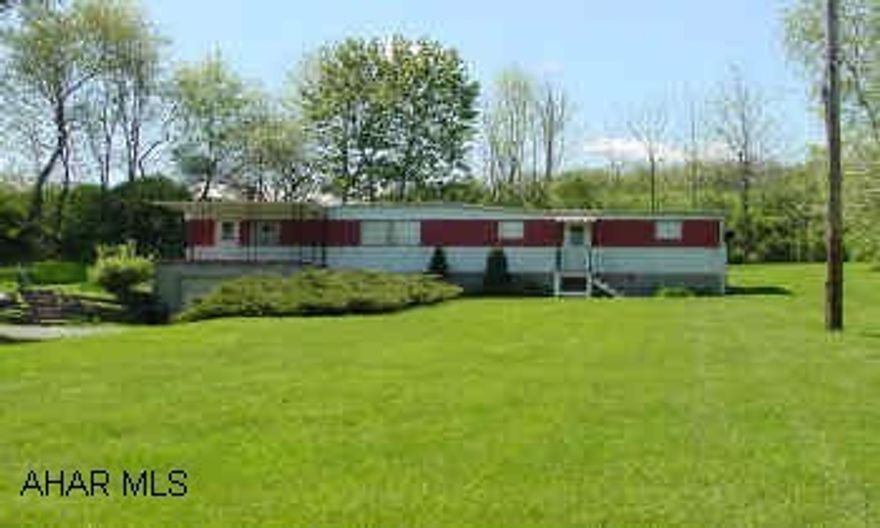 NICE SETTING.  WELL CARED FOR 60X12 1969 MOBILE HOME ON A FOUNDATION WITH COVERED PORCH.  SHARED WELL.  PRIVATE BACK YARD.