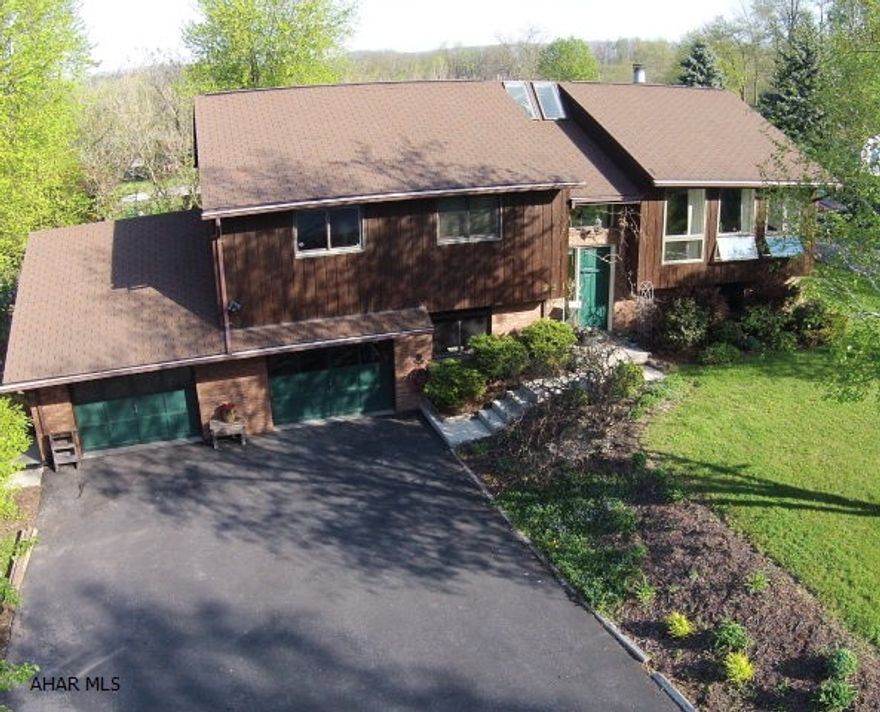 Cedar Contemporary Home with Vaulted Ceilings.   Large fenced in lot with outdoor entertaining area.  Fantastic views and quiet location.  This home features 3 Bedrooms on the main floor and an additional office or bedroom on the lower level.  Open floorplan with floor to ceiling fireplace, hardwood floors and lots of windows to allow the outside in.  Large lower level family room with a walkout basement to a covered seating area and water feature.  Two car garage which bumps out the floor plan for additional space.  Don't miss this opportunity to own one of these unique custom cedar homes.