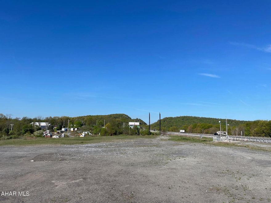 Discover an opportunity with great potential in advertising near the hub of Breezewood, Pennsylvania, prominently known as ''The Gateway to the South.'' This large tract of vacant land lies directly between the Pennsylvania Turnpike and US Route 30, with additional  easy of access via Interstates 70. This positioning makes it a critical junction for substantial through-traffic, ideal for businesses targeting a mix of local and transit audiences. Currently, the site includes several billboards along the Turnpike. THE PROPERTY IS BEING SOLD AS-IS, the billboards may or may not be compliant to new billboard regulations. Sellers will make no repairs or removal of items on the property. Buyers are to do their due diligence and if you enter the property it to be done at their own risk.  This property serves as a blank canvas  to tap into Breezewood's significant commercial potential and embracing the flexibility this location offers. With high Annual Average Daily Traffic counts reported by PennDOT, the visibility and accessibility of this site is ideal for anyone aiming to capitalize on its location and the constant flow of potential customers