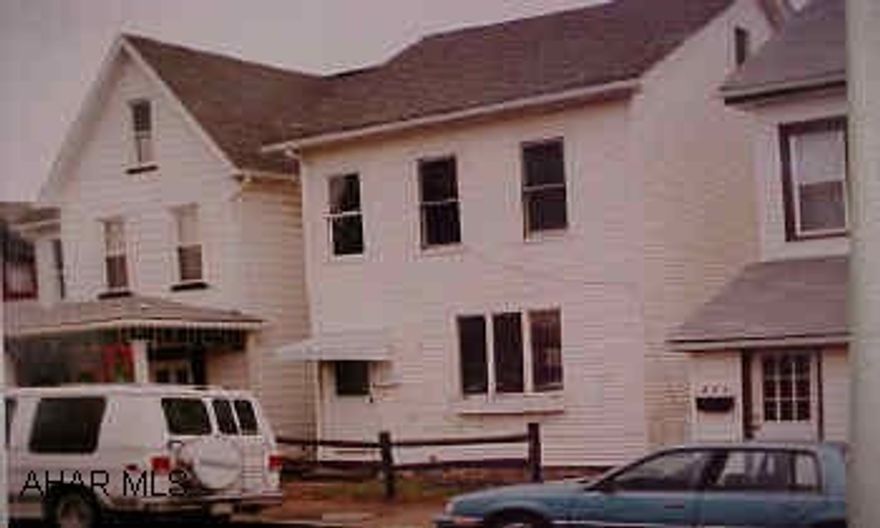 White 2 story vinyl sided.