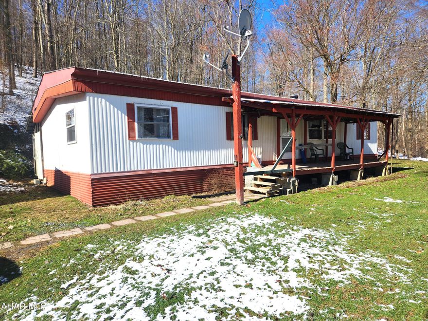 Attention buyers who are looking in the Chestnut Ridge School District.  This move in ready double wide on 8.15 acres needs a little updating, but may be just what you are looking for.  It features 3 bedrooms, two full bathrooms and a laundry room.  The kitchen features maple and cherry cabinets, maple flooring and a dining area.  The spacious living room is carpeted and has a wood burner.  The bedrooms are carpeted.  The front covered porch is a great place to sip your morning coffee, or have an evening chat, whlle listening to the sounds of nature.  With a mixture of wooded and open land, there is plenty of space to plant a garden or fence in a pasture for horses.  At the front of the property you can enjoy the sounds and tranquility of the babbling stream.
Conveniently located just a short drive from Bedford, this property offers the perfect balance of seclusion and accessibility. Enjoy the peace and quiet of rural living while still being within reach of modern conveniences, shopping, dining, and entertainment options.  It's located close to Shawnee State Park, State Game Lands and a short drive to Blue Knob State Park, Hidden Valley and Seven Springs. Come take a look, this may be just what you are looking for.