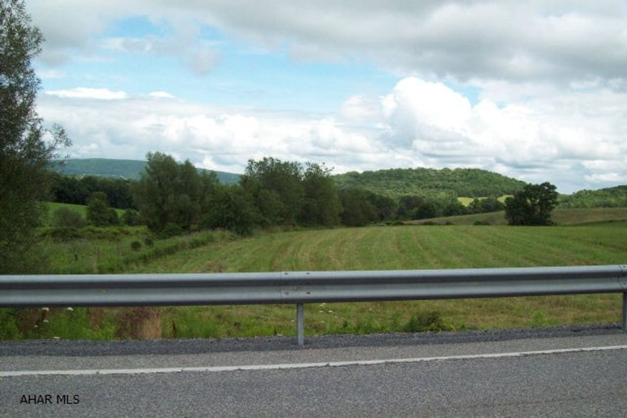 Mostly open rolling ground and some woodland. Accessible along Rt 56 or Hickory Leaf Rd. Public sewer available.