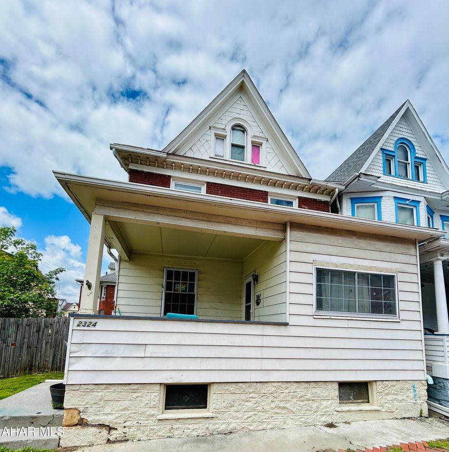 This house is located on 2 parcels of land with plenty of room to update it both inside and out.  The home has 6 possible bedrooms (4 on the 2nd floor and 2 on the third floor), 2 full baths, covered closed in back porch, large fenced in yard, first floor laundry, and plenty of living space.  Put your own personal touches to bring out the beauty of the stain glass window and beautiful staircase. Currently used as an investment property with rental certificate. Tenants are long term.   Set up your showing today.