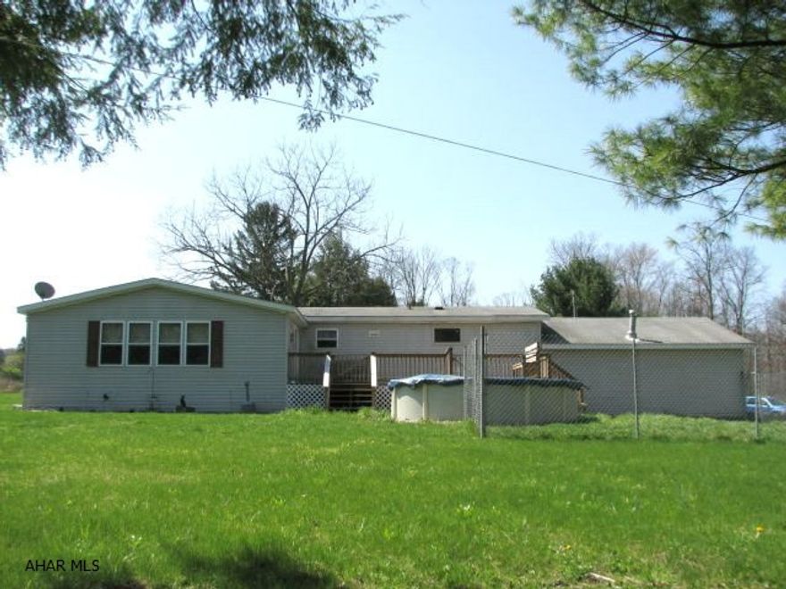 Beautiful and spacious triple wide along the river in Bellwood Antis School District. Above ground pool, deck, covered porch, horse-shoe pit, brick fire pit, 2 car attached garage, breezeway and more. Lot rent is $225.00. Must see. Very nice property.