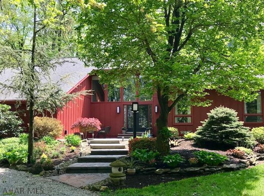 This is NOT your average house!  This beautiful home has a touch of a Frank Lloyd Wright!  A very private retreat surrounded by woods, gorgeous landscaping, stone stamped sidewalks & patio overlooking koi pond on 2.33 acres.  A Mendota gas fireplace centers the living rm & dining rm with vaulted ceilings, beams & pocket doors. Kitchen has Stainless Steel appliances, corian counters and solid bamboo flooring.  1st floor laundry/mud rm with entrance to outside or garage.  Large Master Bedrm has new carpeting, vaulted ceilings, a window can be opened to overlook the living room, with gorgeous views of the yard. HUGE Master Bath with spa-like soaking tub.  Basement has bar area, family room - 37x23 ALL FINISHED!.THIS IS A MUST SEE HOUSE!  Meticulously maintained. (Rm.measurements are approx.).