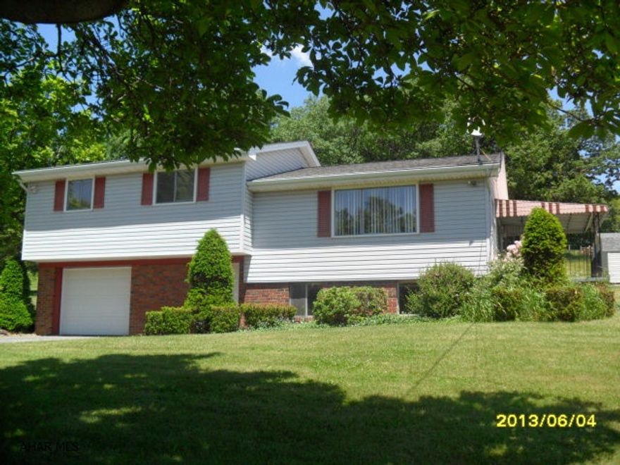 Siding & roof - 6 years old - heat pump system with oil heat - heat pump ( brand new). New kitchen just installed - hardwood floors, carpet just pulled up and could be replaced, (strips still there), or could be finished for $3000.00 New 2nd bathroom in basement, shed has been redone on exterior. 1.77 acres of beautiful ground with numerous fruit trees. Large carport to the side of property. Perfect family picnic pavillion, sewer is going to be in with a proposed start date sometime in the fall. Sewer tap fee to be paid is $1450.00. Agent is related to seller.