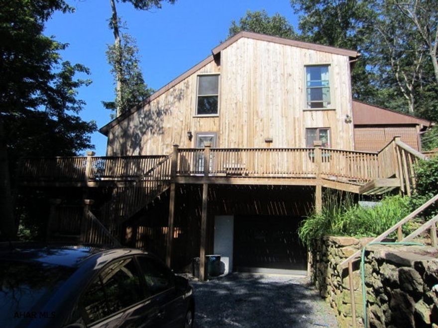 This is a beautiful cedar sided home on approx 1 1/2 acres.  There is an upper and lower deck accessible from sliding doors on both levels.  There is a den on the main floor or could be a 3rd bedroom.  Decks surround the main level and there is a covered back porch for relaxing.  The master bedroom also has a deck with sliding doors to watch the deer roam at night.  The living room is picture perfect with a loft above.  The basement is partially finished and could be a family room or a 4th bedroom.   This property is beautifully landscaped and ready to move into. This is a must see home.