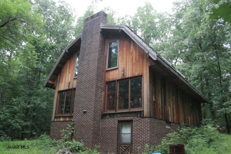 House is partially finished and would livable while being finished. House needs to be completed but many of the materials needed are on site. All situated on 22 wooded flat acreage. cedar sided with cedar shake shingled roof. cedar walls inside.
