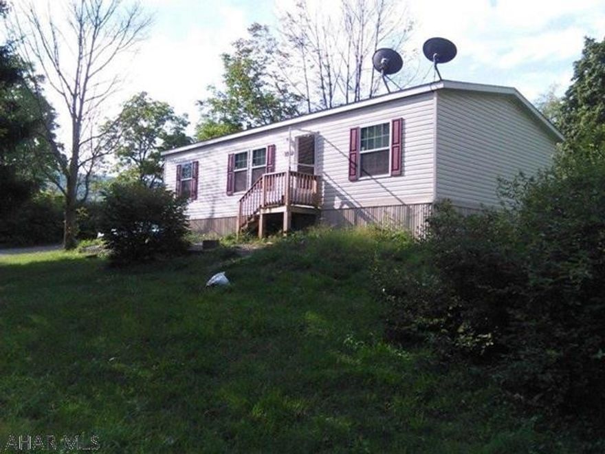 Three bedroom double wide mobile home with 2 bathrooms. On a large corner lot in the the Hillcrest Park with lot rent $297.00 per month that includes water, sewer and trash.