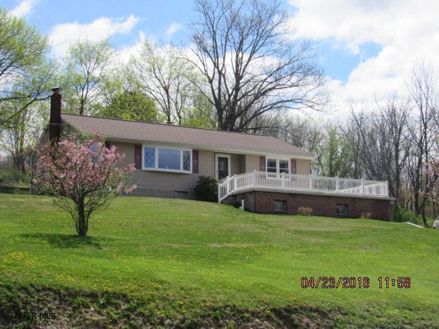 Great rancher on 1.73 acres in Logan Township. Large rooms. City water and sewer plus a  well on the property. Great view! Partially finished basement with family room and fireplace. 2 Car garage, central air, hardwood under carpet.
