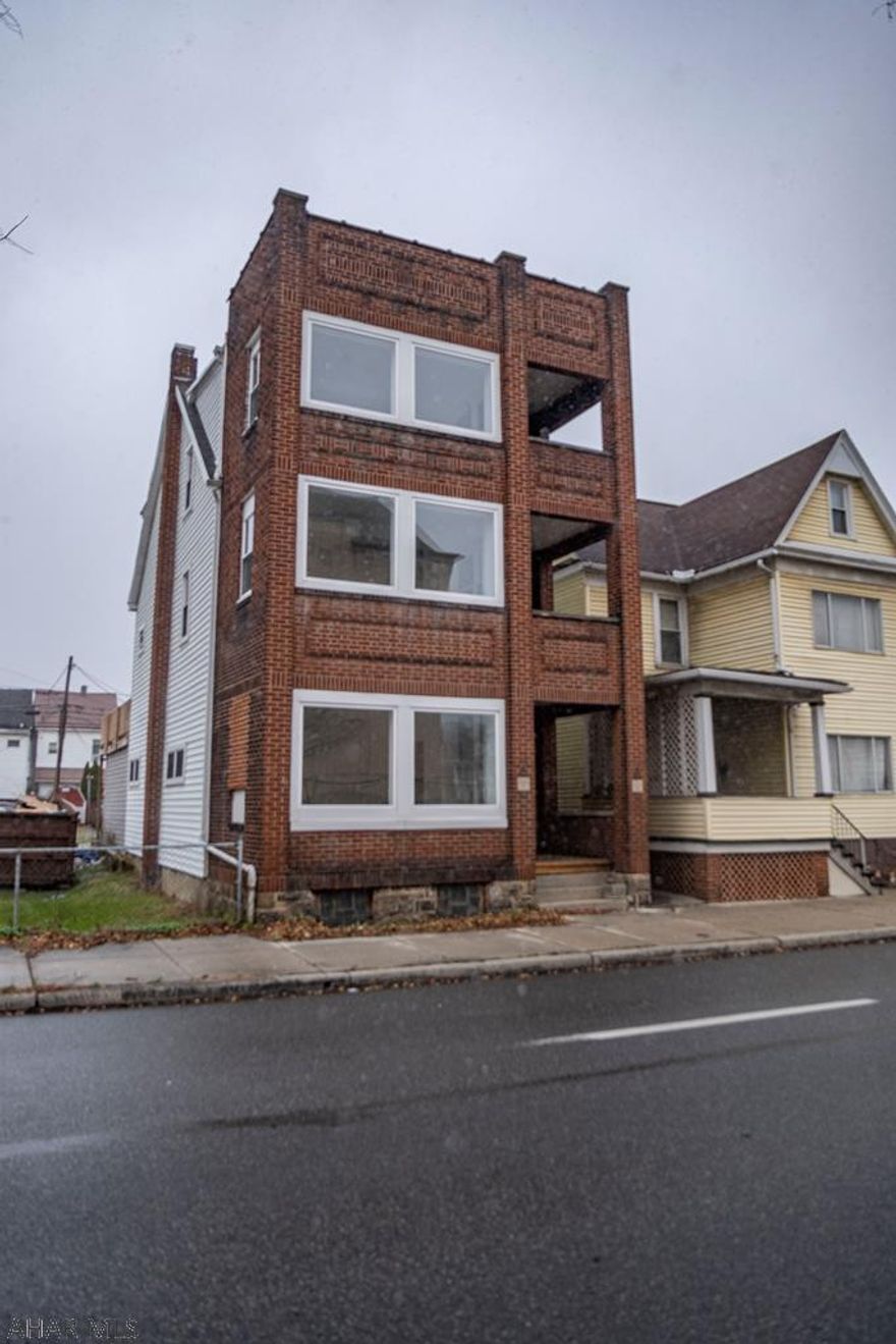 Spacious 2 unit building with so many possibilities. All new flooring, windows ,doors,  etc.. So many unique features . Kitchens and Bath have not been done. Finished out this would make a stellar rental.  Great location . Plenty of out door balcony space . Plenty of off street parking. A must see.....