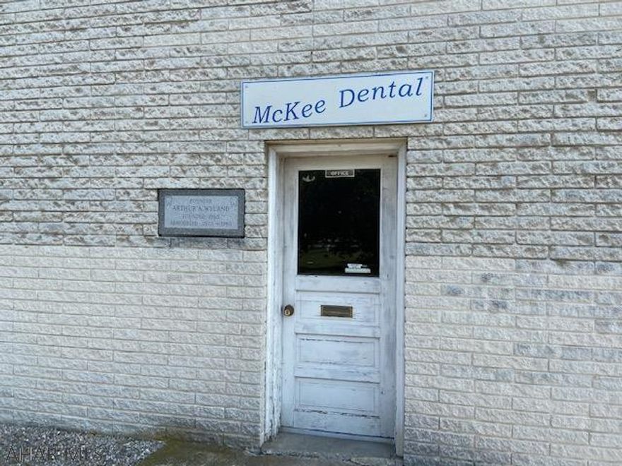 This is the former McKee Dental Clinic which was in operation until December 2019 at least on a part time basis.  The property has 3 one-bedroom apartments upstairs each with individually zoned heat.  All apartments are now vacant with the last tenant having moved out in May 2020.   Main floor has the dental clinic with reception area, large office area, 5 exam rooms, work space areas and 2 very large work area rooms with individual work spaces.  Lots of cabinetry.  Central vac system.  Main floor with office has central air.  Also included with the property is a 28 X 160 lot that has to have a well drilled and can be used for parking.  Current well water source was grandfathered in by current owner but now that this property is being sold the buyer will have to drill water source.