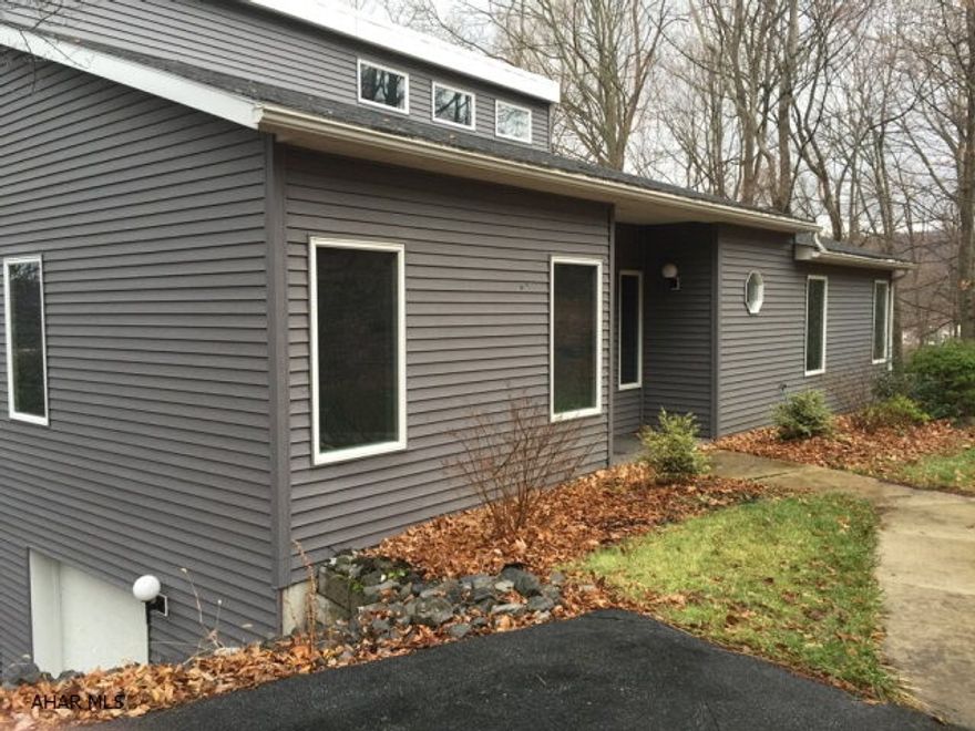 This contemporary designed home located on two building lots was inspired by magnificent views of the town below and is located in one of Bedford's most desirable areas. Not one, but two master suites enjoy stunning views, designer bathrooms and French doors that lead to private decks. Vaulted ceilings enhance the bright and open concept. The large maintenance free Trex decking is great for entertaining as it is conveniently located off of the dining and living areas. A huge bonus room found in the lower level also takes in tremendous views. A two car garage and energy efficient natural gas furnace make this home a tremendous value.  Room sizes are approximate!