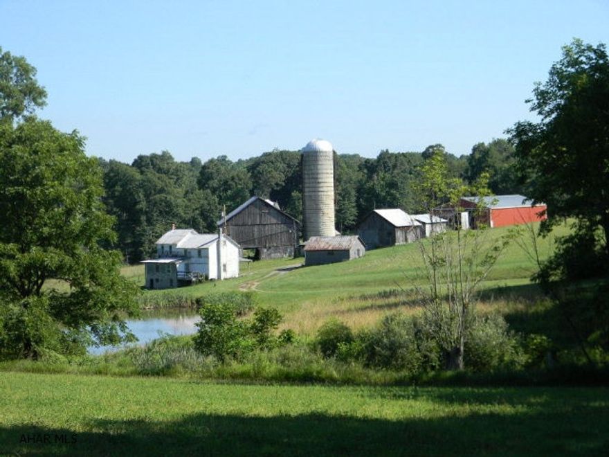 Old 4 bedroom farm house with two barns and five various wagon and machine sheds on 46.71 scenic and rolling acres. Farm pond in serene setting. Contains 31 crop productive acres, with the remainder woods and pasture.