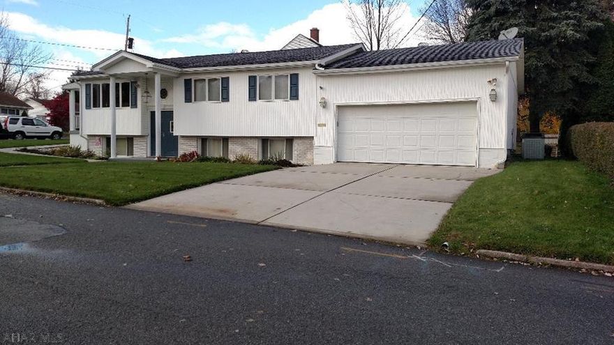 Technically a bi-level, but if you walk in the house from the covered patio, you feel like you are in a ranch home.  It is spacious, clean, and bright inside.  There are h/w floors under the carpet in the living room, dining room, 3 bedrooms & hallway.  The seller doesn't remember them ever being exposed.  The kitchen has a modern, neutral-colored tile floor, nice counters, and well-made cabinets.  Solid oak doors & trim & newer windows.  The seller will give a credit at closing to have the family room carpeting replaced.  The gas, hot-water furnace has 4 zones.  The first floor has c/a and several lighted ceiling fans.  The 2-car garage has high ceilings & is attached, not integral like in most bi-levels.  Corner lot. This property qualifies for a USDA loan (no money down).