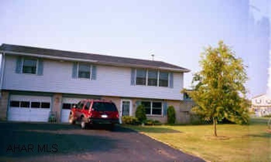 Raised Ranch with large living room and finished basement on large corner lot.
