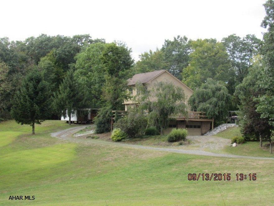 Beautiful and Unique. Great home nestled in privacy on 13.7 +/- acres. 3 Bedrooms and 4 baths. Eat-in kitchen with all the appliances and large pantry! Large living room with doors to the deck and a wood burner. Wood burner is set up to heat the entire home. Vaulted wood beamed ceilings throughout. Large master bedroom with a great master bath with jetted tub! Finished basement offers another wood burner, 3/4 bath, laundry and bar area. Huge wrap around deck for entertaining and watching the wildlife. Brand new windows throughout.