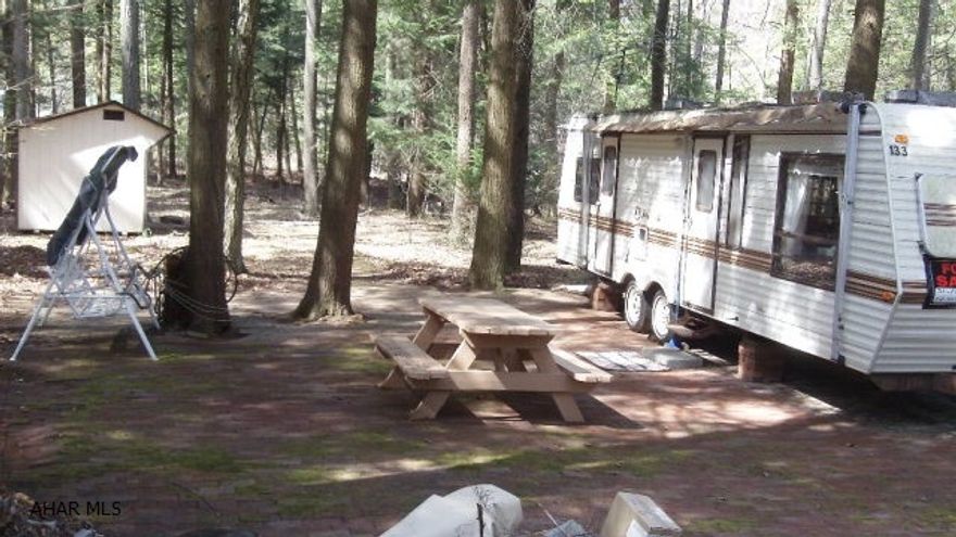 Relax and enjoy the peace on this tucked in campsite.  A brick patio and path to your shed are nice accents.  Plenty of room for your picnic and outdoor activities.  The trees surrounding you will keep you cool in the summer.  A good place to watch for wildlife.  Located in Glendale Yearound with all the amenities of the community which is adjacent to Prince Gallitzin State Park and Glendale Lake.  Only six miles from Rock Run ATV Park.  Come and see what you've been missing.