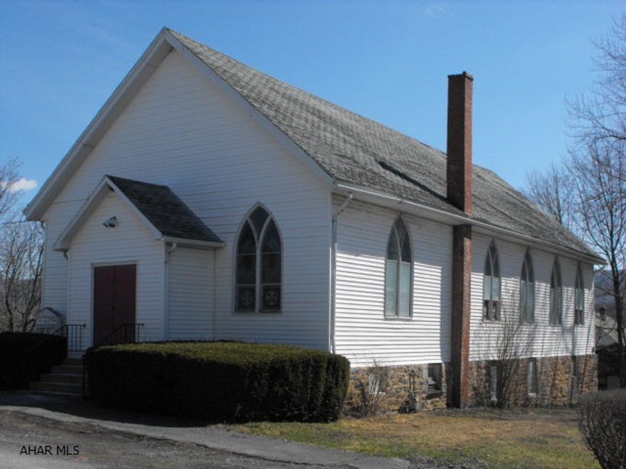 Great possibilities for different uses.  Could be renovated into living space.  12 stained glass windows, altar, & pews all stay with property.  This is an As Is Sale.  Building needs a roof and a new gas hot water furnace. Full basement with mens & ladies rest rooms.