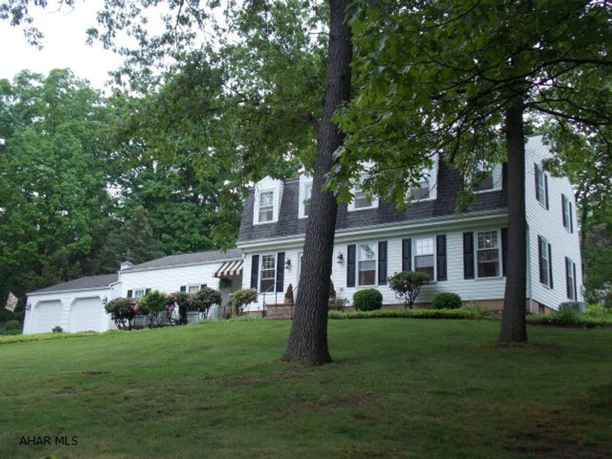 Stately home with so much character and charm. Huge LR & DR with hardwood floors and crown molding, will be a great place for Thanksgiving. Family room is so inviting with a wood burning fireplace and is separated from the office with pocket doors. You will love the four season sun room with skylights and wall to wall windows, sit and read a book while you watch it snow this winter. The rec room with a bar is a great place to play pool and watch the big game. All of the bedrooms are large and have hardwood floors and crown molding. The basement is also finished to give more space for crafts or sleep overs. The wooded lot is over an acre and gives so much privacy for picnics or bonfires and there is plenty of room for a pool. Home is approximately 4,200 sq. ft.