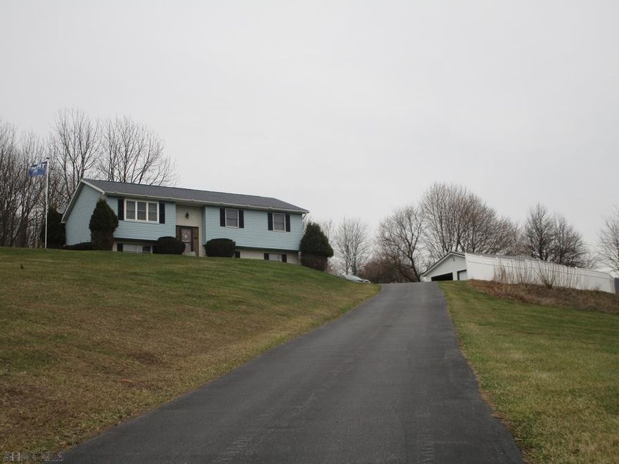 Great location in Bellwood school district this split entry home features 3 or 4 bedrooms, 1.75 baths, large living room, oak eat in kitchen all on a private 1.9 acre lot.  Nice view and paved driveway and parking along with a 2 car detached garage. Nice country home.