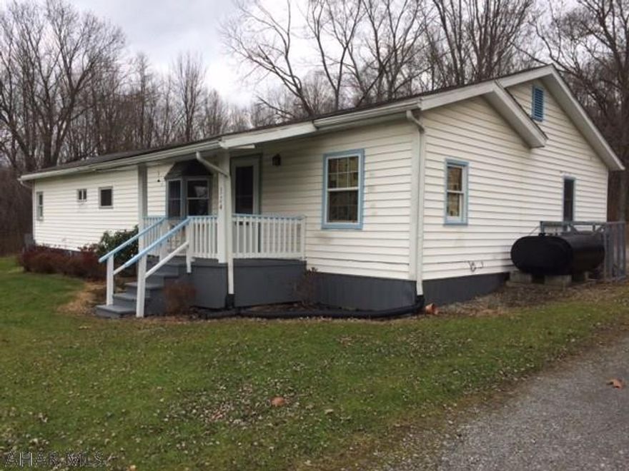 OWNER SAYS SELL! - Logan Twp. Seller looking for CASH buyer and is selling As Is. Beautiful level 1 acre lot in Logan township with a 3 bed 1.5 bath home that has many updates. A portion of the home was a manufactured home from the 1970's, but recent additions including central air, large living/family room, master bed and 1/2 bath ($30,000+) also new roof only 4 years old.  Tree lined and level 1 acre lot sits back and would be a great building lot. Home is currently heated by heat pump, but there is an oil tank and lines so easily converted back to oil forced air heat also room to add a shower in bath off master. Land has been surveyed for public sewer; anticipated tap on fees $1540. 2017 Estimated taxes are $996.00 with assessed value of $84,100.