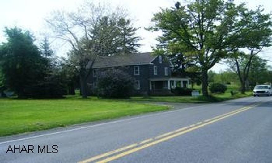 Old, 2 story farm house on 2.7 acres. House needs totally renovated. Old style septic system and well.