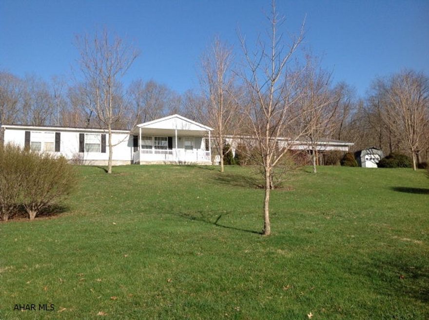 Spacious doublewide on 2.26 acres. 24x24 2 bay carport with cement floor. 14x30 shed for storage. 19x8 cement front porch and vinyl railing, 16x18 wood deck off kitchen, Large walkin closet in master bedroom with a 10x12 sitting room. Block crawlspace foundation. Bathroom with skylight.  Master bath with double sink, garden tub and seperate shower.  Nicely landscaped with privacy and beautiful view of the country!!