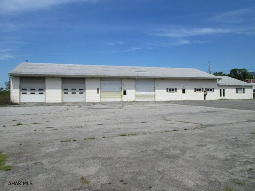 Commercial building on 2.86 acres. Exterior is steel construction and steel roof. Many possible uses as there are two warehouses with approx. 3760 sq. ft. & office space with A/C total 2655 sq. ft. Paved parking lot. Call office for layout of interior.