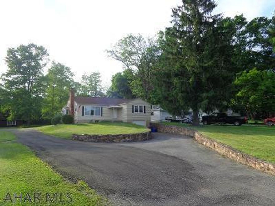 You belong here!  Very attractive 1.5 story home with .77 acres in a desirable neighborhood.  Newer roof, hardwood & ceramic tile floors, sun porch, deck, garage.  The finished basement has a bar & sauna.  Home has been recently appraised for $180,000.