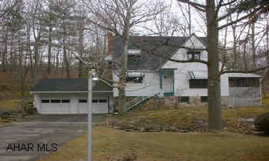 2.5 STORY CAPE COD. 3 BED., 1.5 BATH, HARDWOOD FLOORS, FIREPLACE, BUILT IN BOOKCASES SET ON APPROX. 2.5 ACRE. 2 CAR ATTACHED GARAGE. 2 PARCELS OF GROUND. LOTS OF CLOSET SPACE.