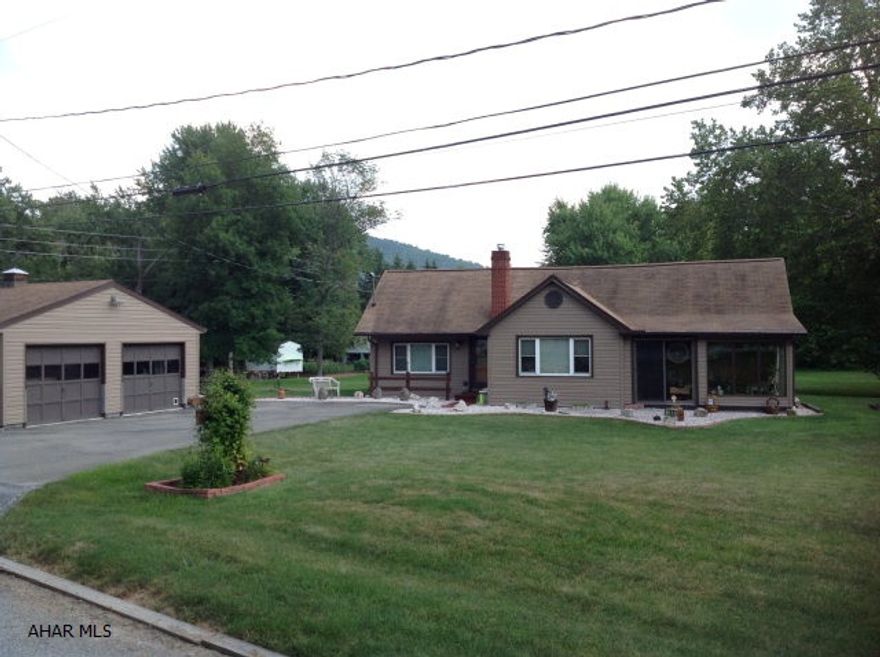 Immaculate/well maintained Ranch home on 1.68 acres. 2 BR 1.5 BA and a detached 24x26 2 car garage.  Galley kitchen with cherry cabinets by Yorktown, new microwave, stove with glass top, Hunter ceiling fans and enclosed front and back sunrooms. Thermopane windows, newer roof and vinyl siding, built-in wall AC, approx. 1000 sqft of floor attic storage.